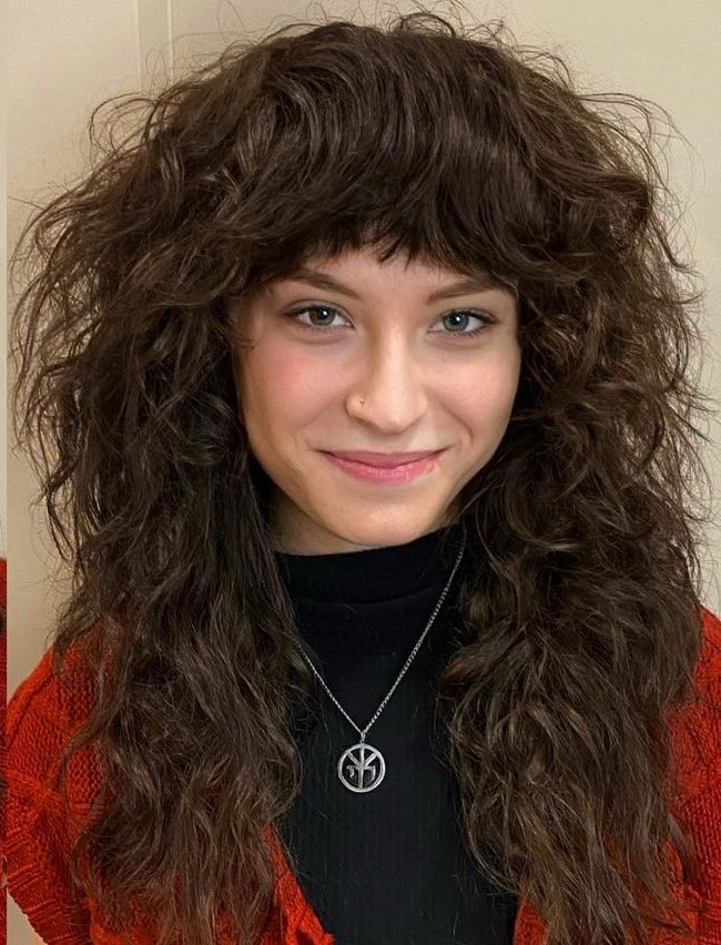 Fluffy Wavy Hair with Lots of Volume Layered Wolf Cut with Thick Bangs on Wavy Hair