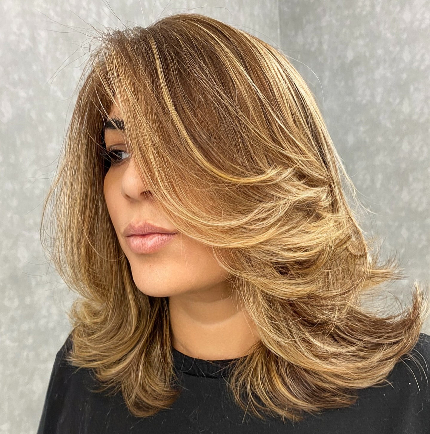 Medium Length Feathered Hairstyle for Thick Hair