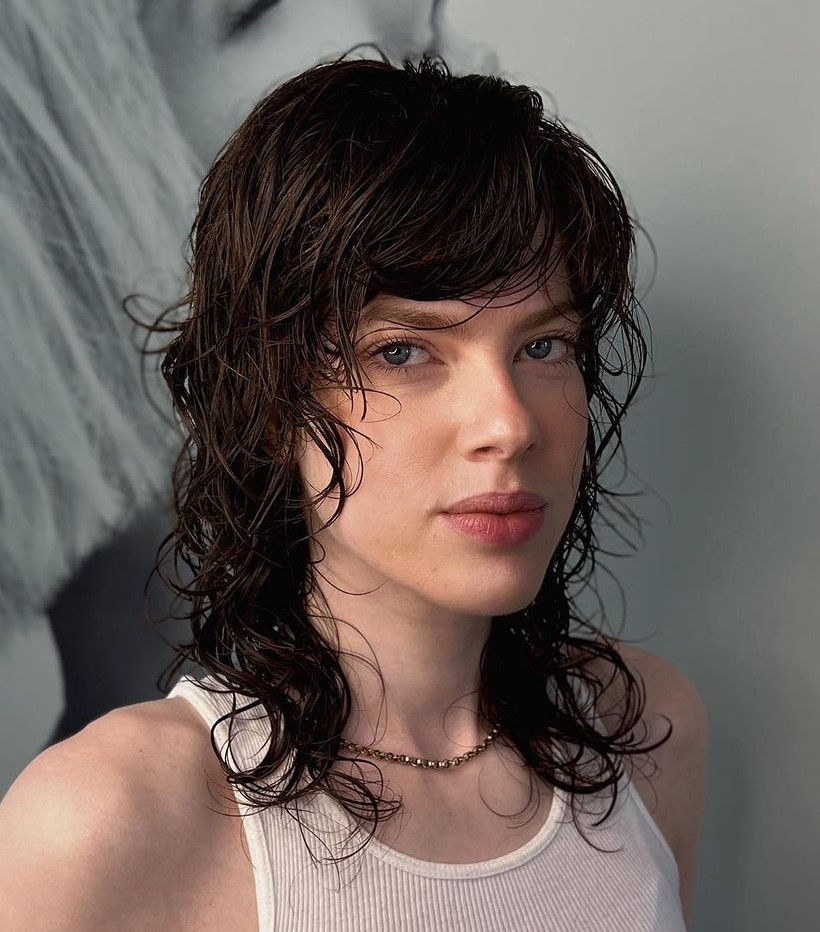 Loose Curls with a Wet Look Medium Hairstyle with Full Side Bangs and Choppy Layers