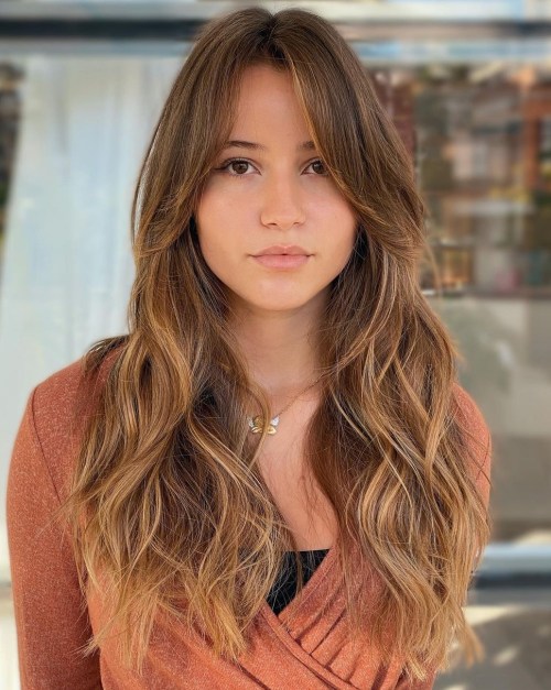 Long Curtain Bangs on Wavy Hair Medium Brown Hair with Caramel Balayage and Face Framing Bangs